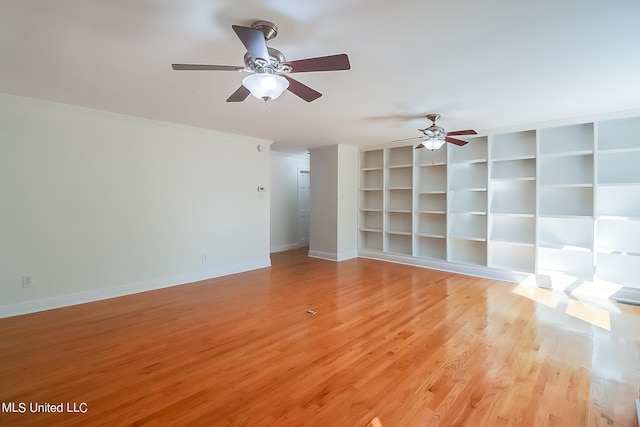 unfurnished living room with built in shelves, ceiling fan, and light wood-type flooring