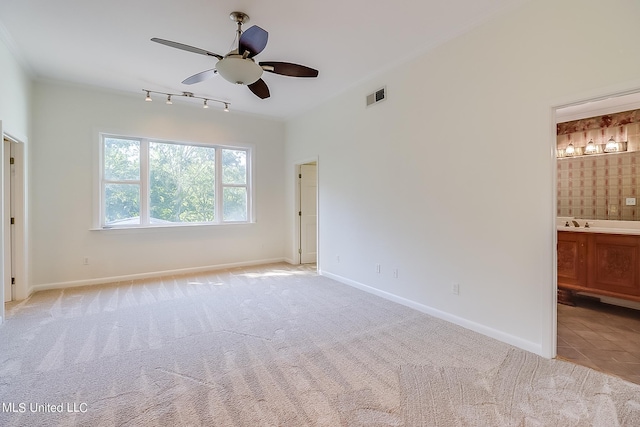 unfurnished bedroom with light carpet, ceiling fan, and ensuite bathroom