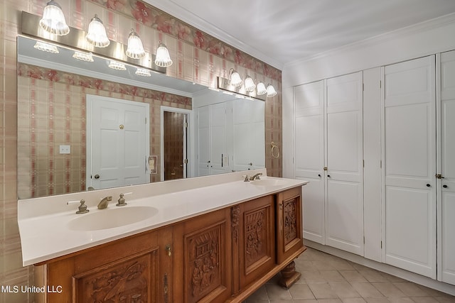 bathroom with crown molding, tile patterned floors, and vanity