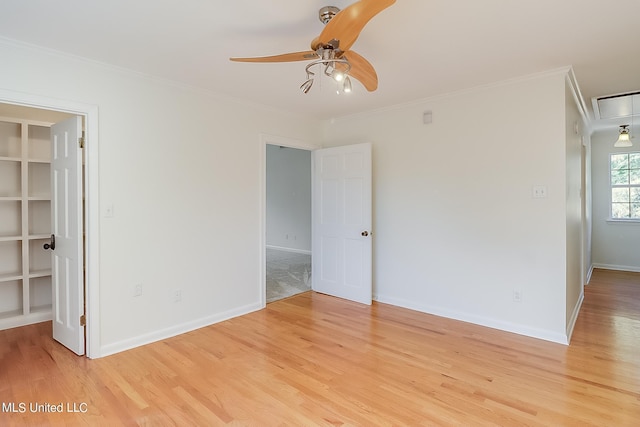 spare room featuring ornamental molding, ceiling fan, and light wood-type flooring