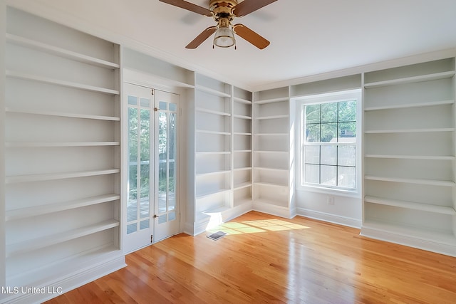 unfurnished room with hardwood / wood-style flooring, ceiling fan, and plenty of natural light