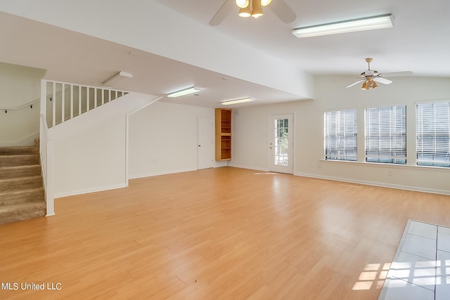 unfurnished living room featuring vaulted ceiling, ceiling fan, and light wood-type flooring