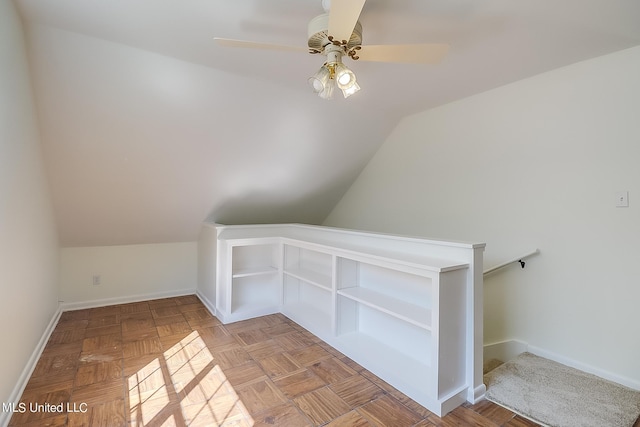 additional living space with light parquet flooring, vaulted ceiling, and ceiling fan