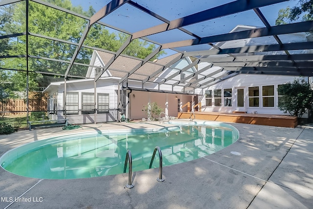 view of swimming pool featuring a wooden deck and glass enclosure