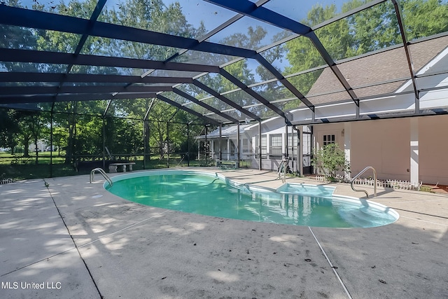 view of swimming pool with a patio area and glass enclosure