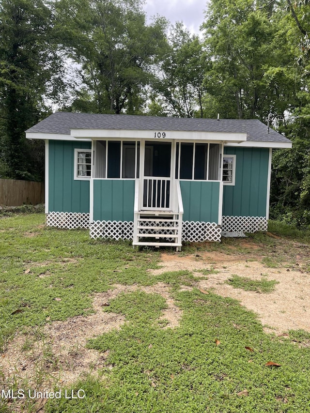 view of outbuilding featuring fence