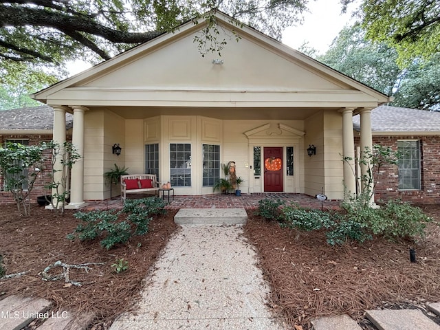 neoclassical home featuring covered porch