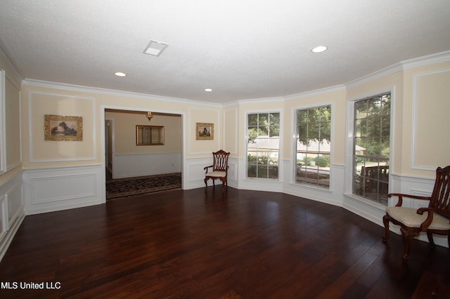 unfurnished living room with dark hardwood / wood-style floors, a textured ceiling, and crown molding