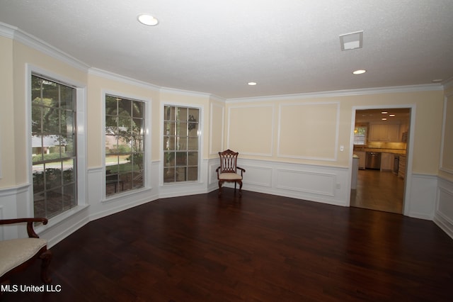 spare room with a textured ceiling, ornamental molding, and dark hardwood / wood-style floors