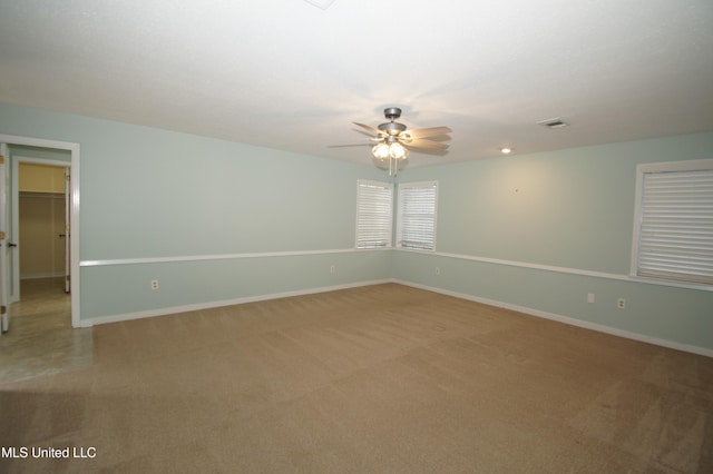 empty room featuring carpet flooring and ceiling fan