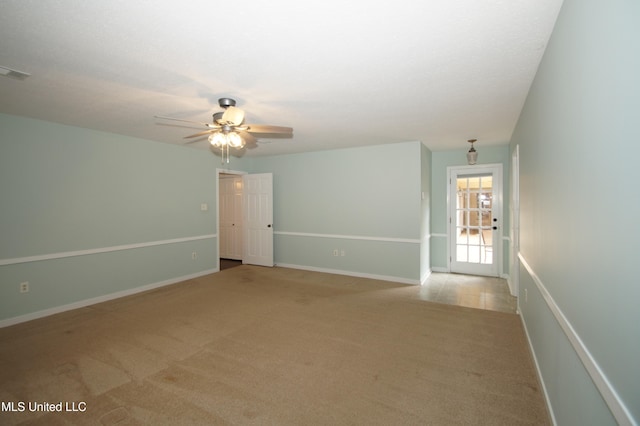 carpeted empty room featuring ceiling fan