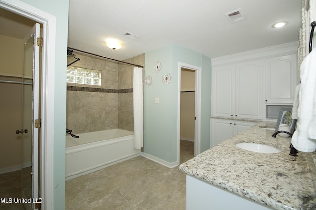 bathroom featuring vanity and shower / tub combo