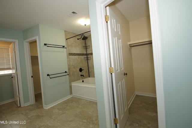 bathroom with tile patterned flooring and tiled shower / bath