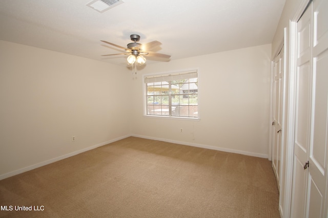 unfurnished bedroom with light colored carpet and ceiling fan