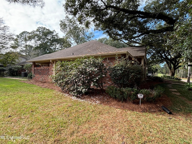 view of side of home featuring a lawn