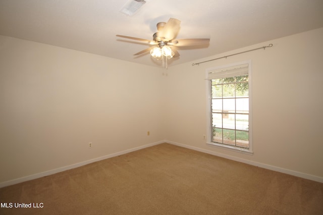 carpeted spare room featuring ceiling fan