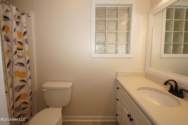 bathroom with toilet and vanity