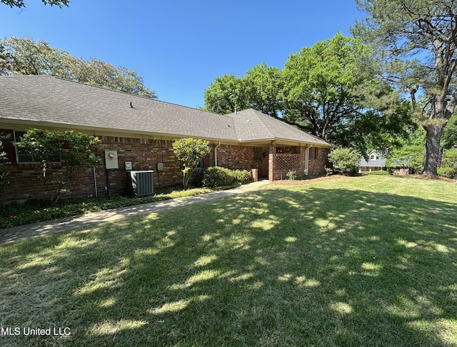 5365 River Thames Rd, Jackson, MS 39211 - exterior space featuring a yard, brick siding, cooling unit, and roof with shingles