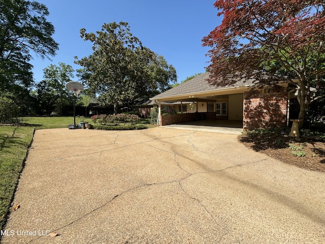5365 River Thames Rd, Jackson, MS 39211 - view of front of home featuring brick siding, driveway, and a carport