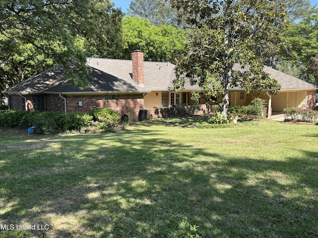 5365 River Thames Rd, Jackson, MS 39211 - rear view of house featuring a lawn, brick siding, and a chimney
