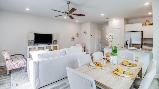 dining room with recessed lighting, a ceiling fan, baseboards, and light wood finished floors
