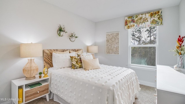 bedroom featuring carpet and baseboards
