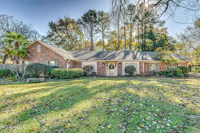 ranch-style home featuring a front yard