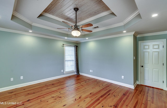 spare room featuring ceiling fan, light hardwood / wood-style floors, a raised ceiling, and ornamental molding