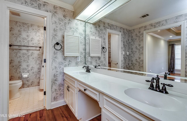 bathroom with hardwood / wood-style floors, vanity, and ornamental molding