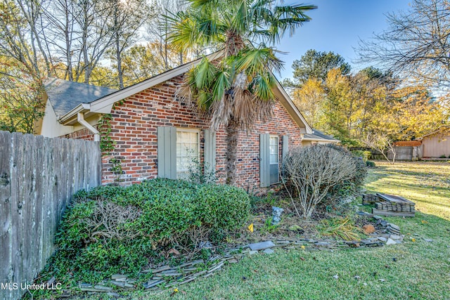 view of home's exterior with a yard