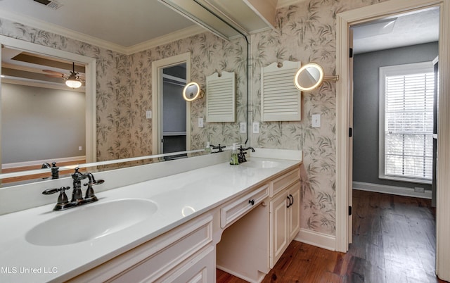 bathroom featuring hardwood / wood-style floors, vanity, plenty of natural light, and ornamental molding