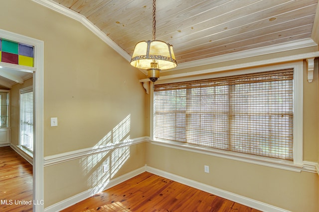 interior space with hardwood / wood-style floors, wooden ceiling, and ornamental molding