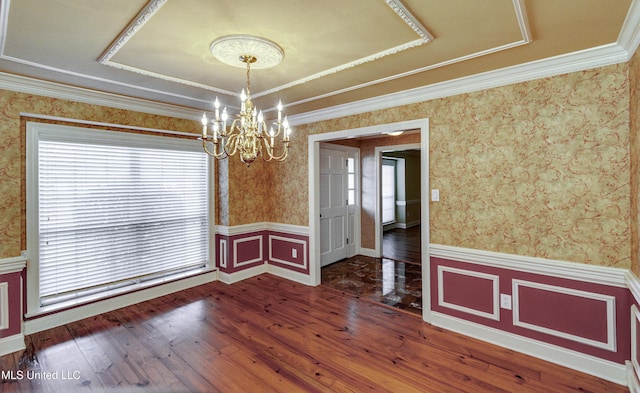 unfurnished dining area with a chandelier, crown molding, and wood-type flooring