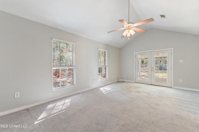 unfurnished room featuring french doors, ceiling fan, vaulted ceiling, and light carpet