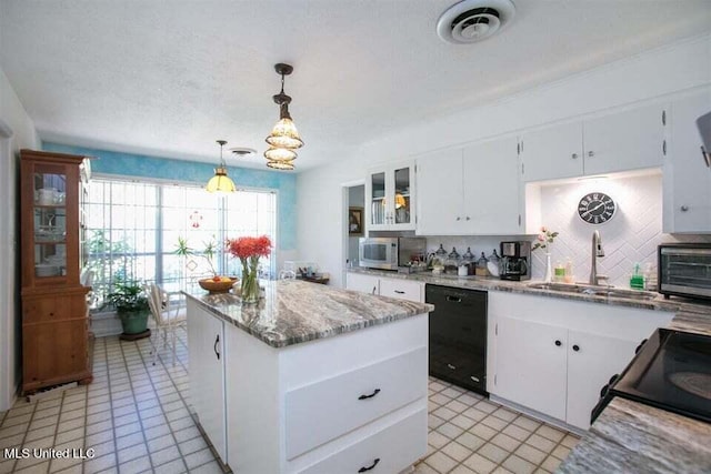 708 Ratliff Ferry Rd, Canton, MS 39046 - kitchen featuring a center island, hanging light fixtures, black dishwasher, tasteful backsplash, and white cabinets