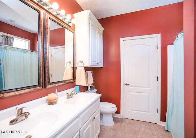 708 Ratliff Ferry Rd, Canton, MS 39046 - bathroom featuring tile patterned flooring, a textured ceiling, vanity, and toilet