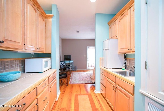 708 Ratliff Ferry Rd, Canton, MS 39046 - kitchen featuring white appliances, tasteful backsplash, tile counters, and sink