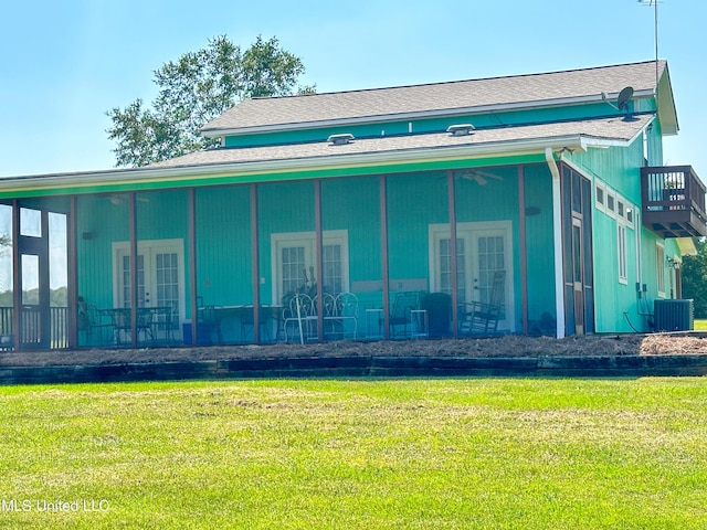 708 Ratliff Ferry Rd, Canton, MS 39046 - back of property with a yard, a sunroom, french doors, and cooling unit