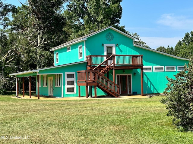 708 Ratliff Ferry Rd, Canton, MS 39046 - back of property featuring a wooden deck and a lawn