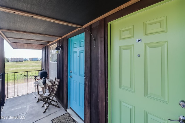 view of exterior entry featuring a porch