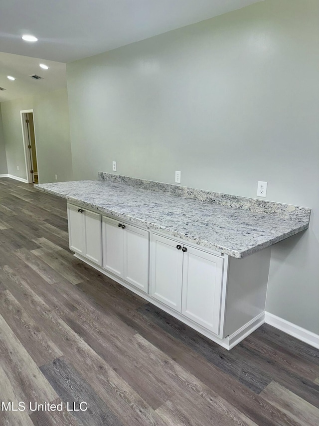 106 Edd Monk St, Mendenhall, MS 39114 - kitchen featuring dark wood-type flooring, white cabinetry, a peninsula, light stone countertops, and recessed lighting