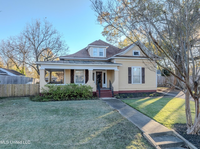 view of front of house with a porch and a front yard