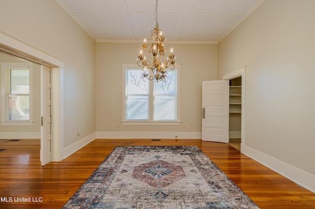 dining room featuring crown molding, a chandelier, and hardwood / wood-style flooring