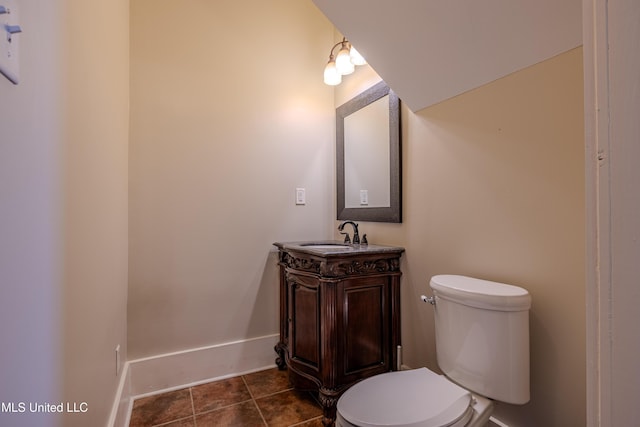 bathroom featuring tile patterned floors, vanity, and toilet