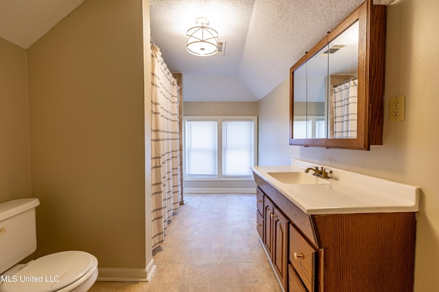 bathroom featuring tile patterned floors, a textured ceiling, vanity, vaulted ceiling, and toilet