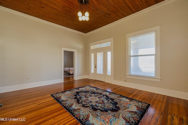 foyer with hardwood / wood-style floors, wooden ceiling, and ornamental molding