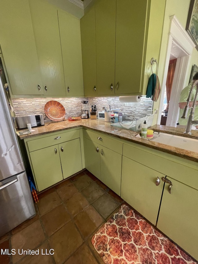 800 Gillespie St, Jackson, MS 39202 - kitchen featuring freestanding refrigerator, backsplash, and a sink