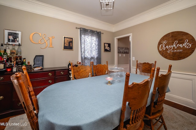 dining area featuring ornamental molding and bar area