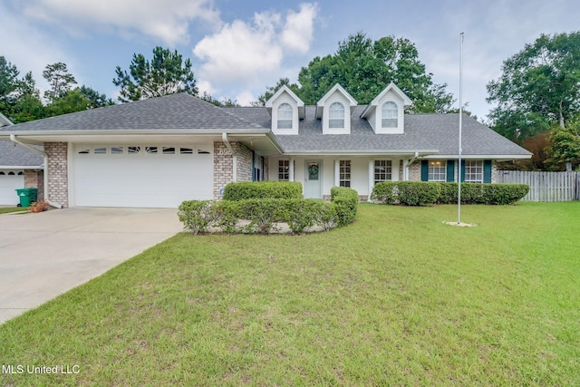 696 Aukai Pl, Diamondhead, MS 39525 - new england style home featuring a garage, brick siding, driveway, and a shingled roof