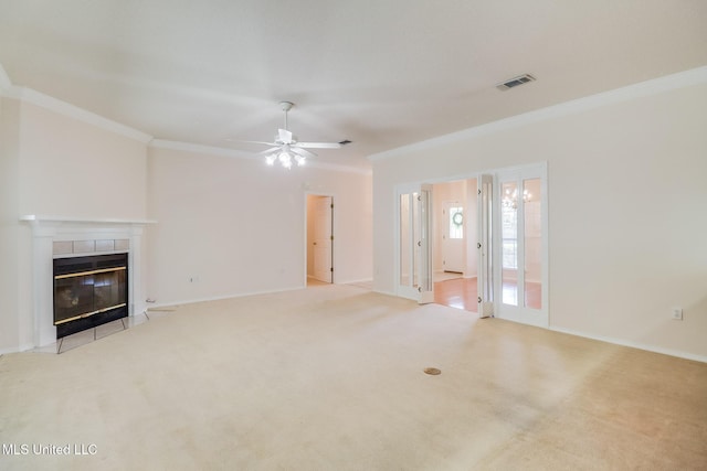 696 Aukai Pl, Diamondhead, MS 39525 - unfurnished living room with crown molding, a ceiling fan, a tile fireplace, carpet flooring, and baseboards